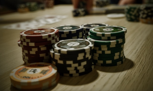A vibrant screenshot of a rummy game table with colorful cards and chips.